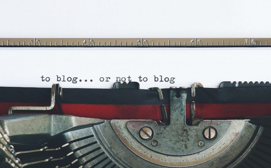 Close up of a typewriter and ribbon with the types words to blog...or not to blog